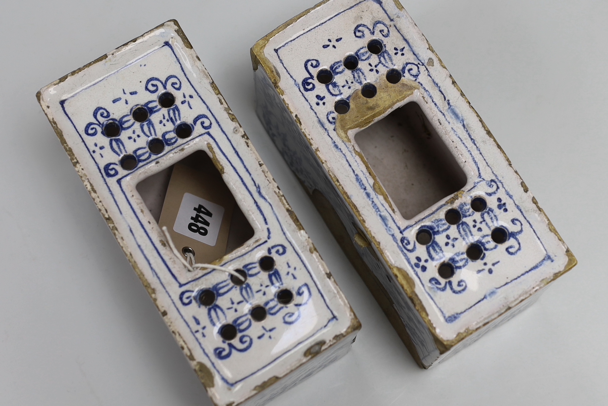 A pair of 18th century Delft flower bricks, 9.4cm high